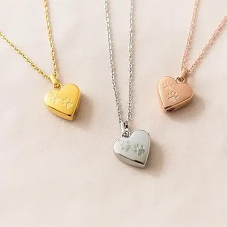 Claire with Paws heart cremation necklaces with paw print details in gold, silver and rose gold