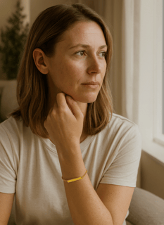 Woman wearing a gold bar cremation bracelet for pet ashes on her wrist